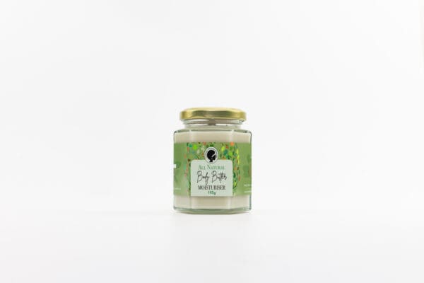 A jar of candle with the label " tea tree ".